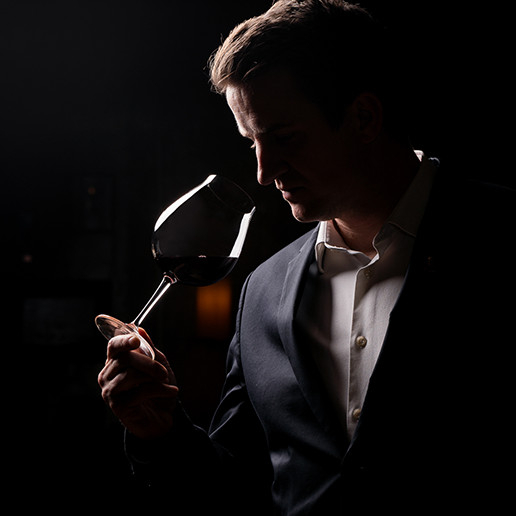 A man smelling a glass of wine at the restaurant Dans le Noir ?.