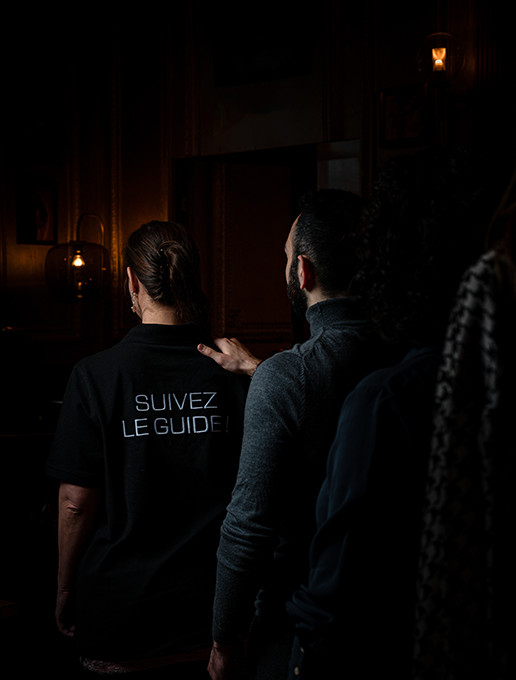 A group in single file celebrating a bachelor party at the Dans le Noir ? restaurant